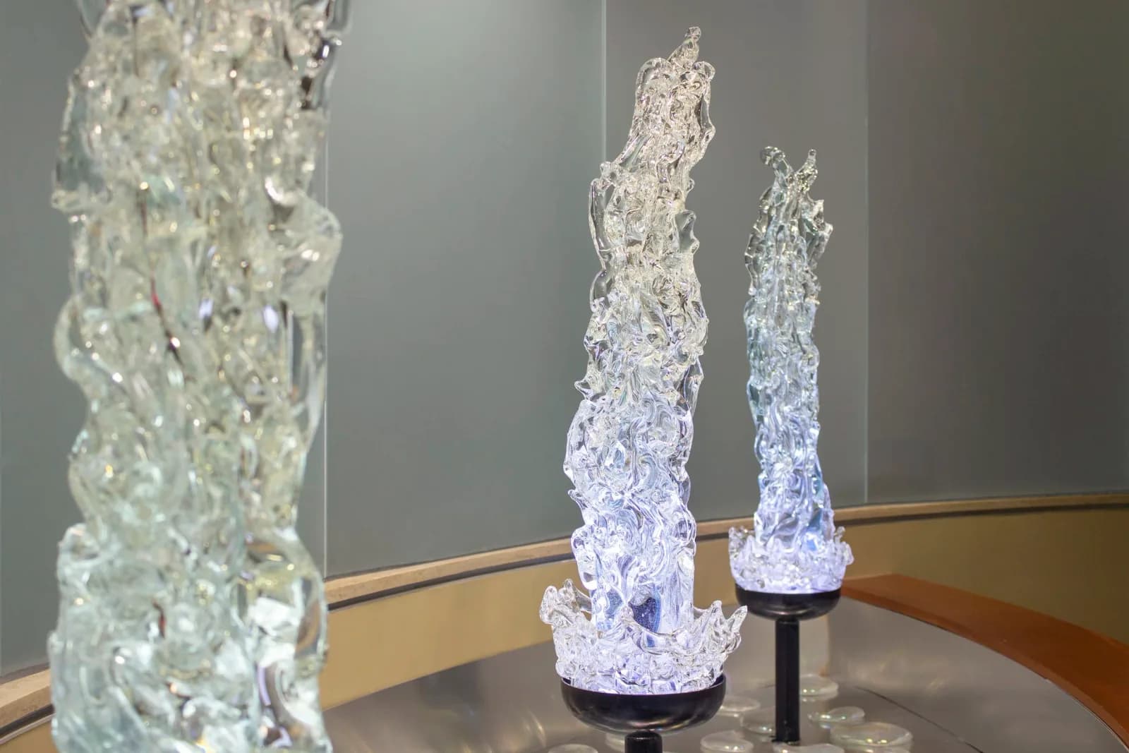 Clear blown glass decanter and two glasses with fine linear patterns