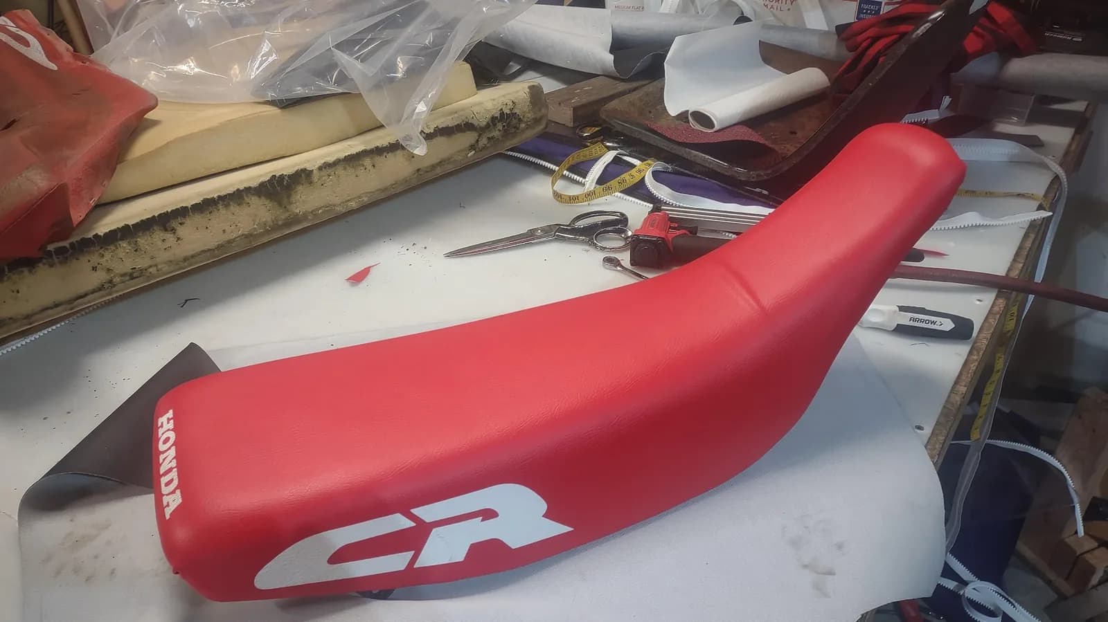 Red Honda CR dirt bike seat after recovering, by Matsu Upholstery