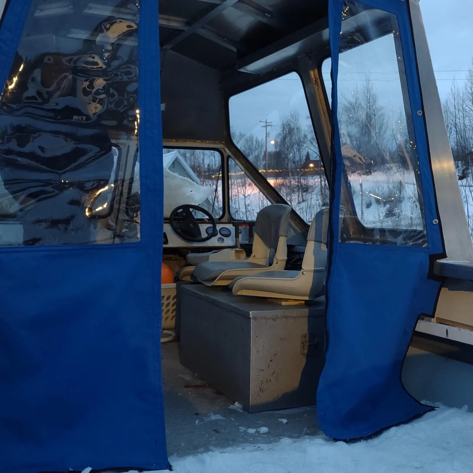 Canvas enclosure panels on a boat cabin, in snow, by Matsu Upholstery