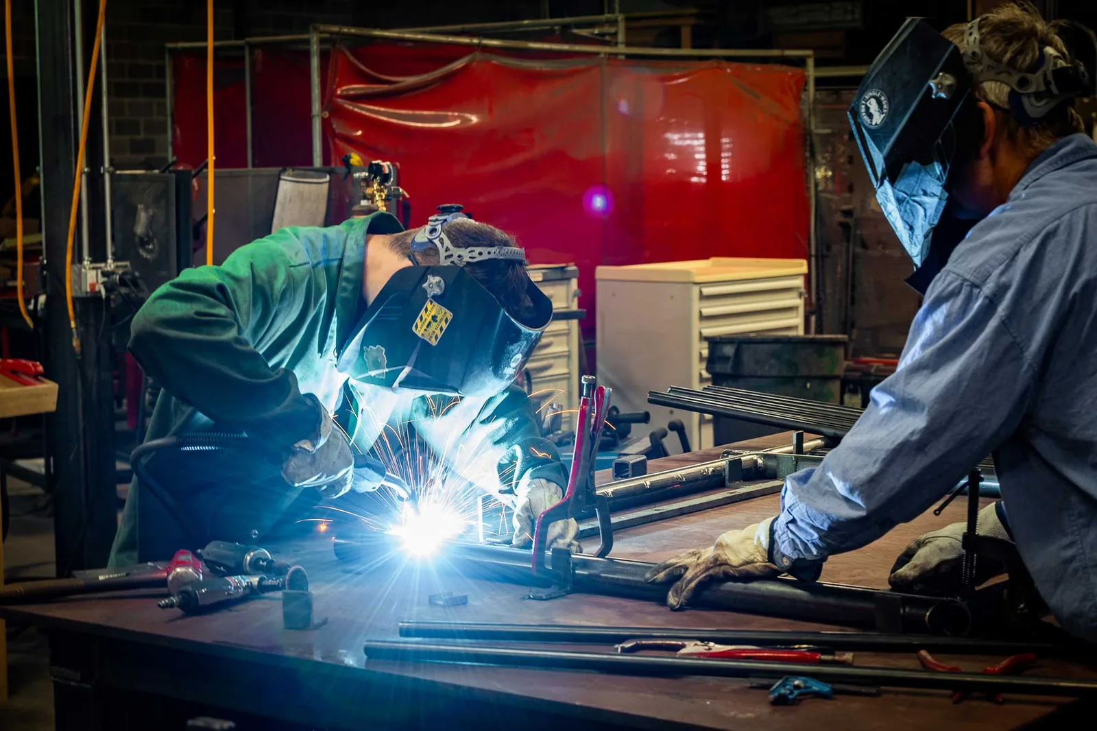 Welders at work in the Stewart Iron Works shop