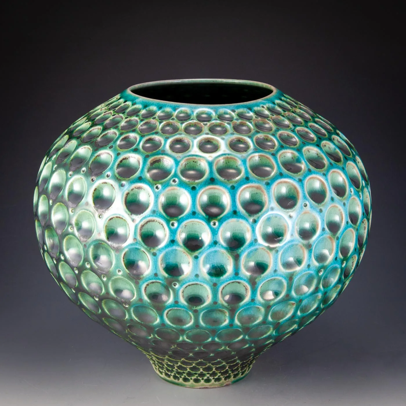 Dimpled BellVen: round teal vessel covered in glazed dimples